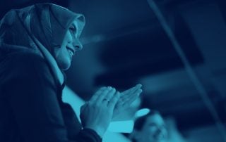Woman in hijab applauding