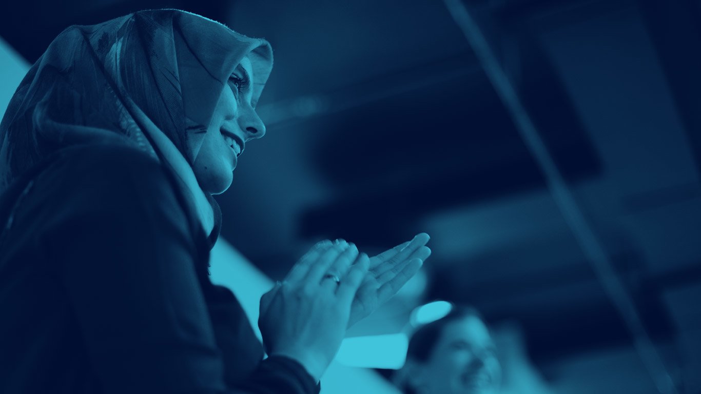 Woman in hijab applauding