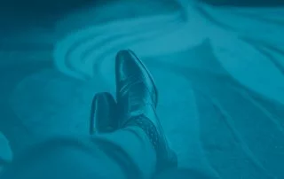 Close up of person's legs crossed, wearing loafers