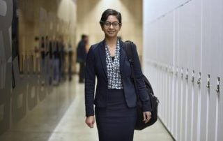 Female MBA walking down hall