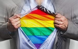 Man opening shirt to reveal Pride shirt