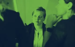 Woman sat in meeting with two female colleagues