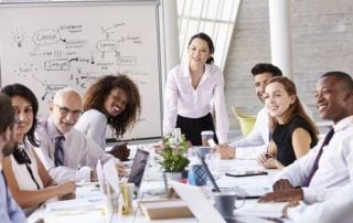 Boardroom discussion with woman at head of table