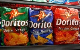 Bags of Doritos on the shelf of a grocery store
