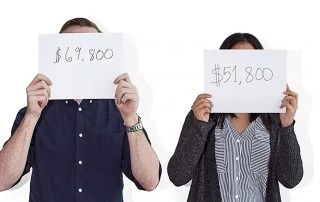 Man holding a sign which reads $69,800/yr and woman holding a sign reading $51,800/year