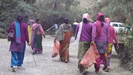 Group of East Asian women picking up trash outdoors