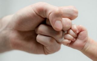 Close up of Father fist bumping child