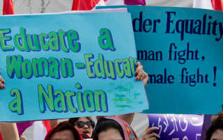 Women protest holding signs for education and gender equity