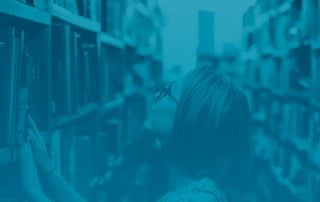 Woman searches through library stacks