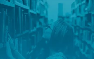 Woman searches through library stacks