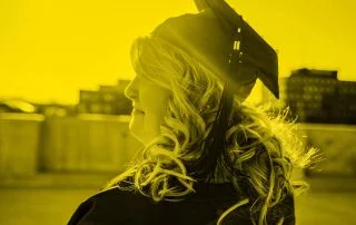 Woman staring into sky wearing convocation hat