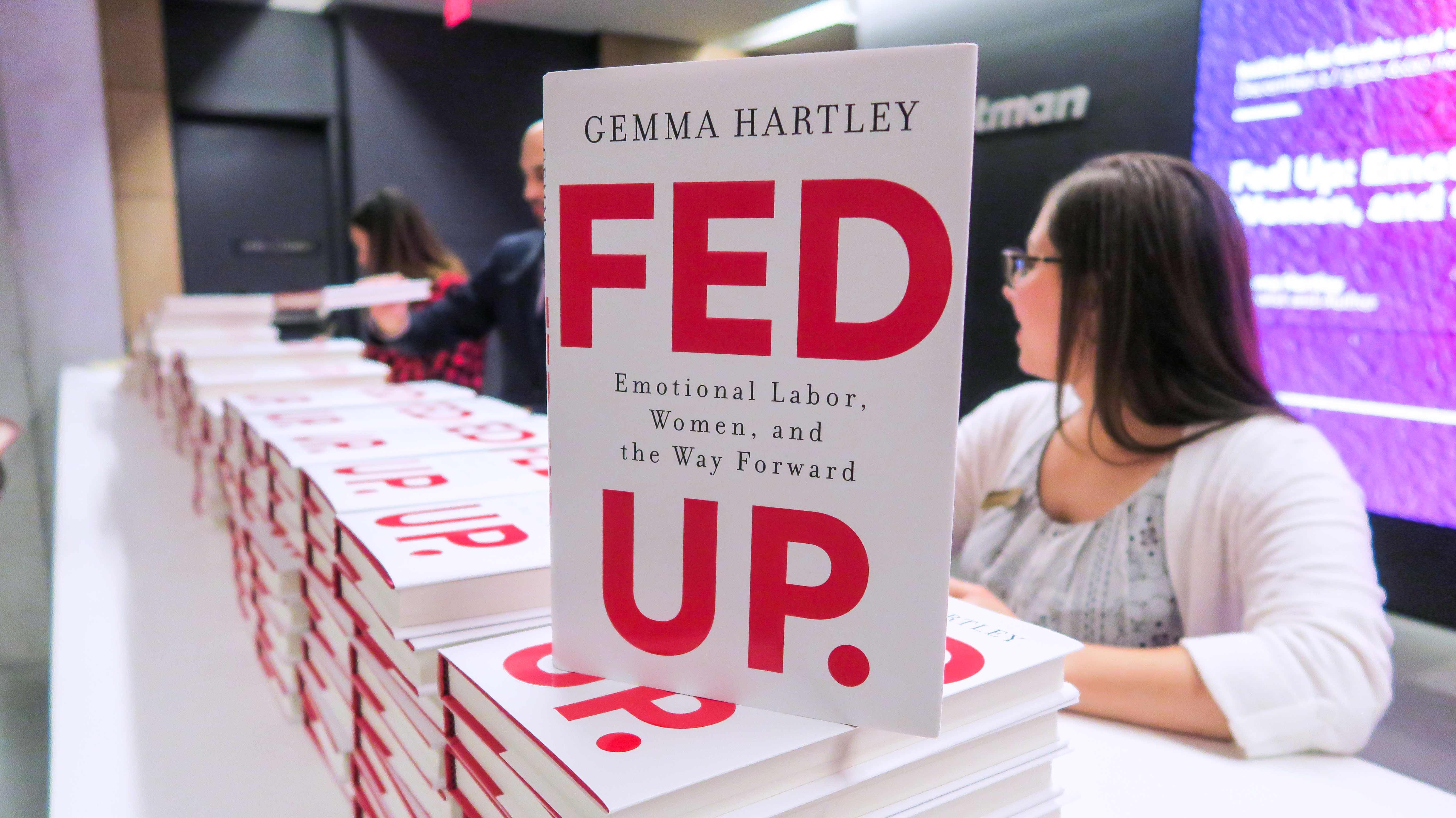 Cover of book "Fed Up" stacked on event registration table