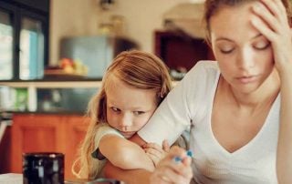 Exhausted mother held by young daughter