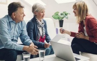 A retired couple speaks to a financial savings consultant