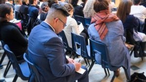 Audience member writing notes