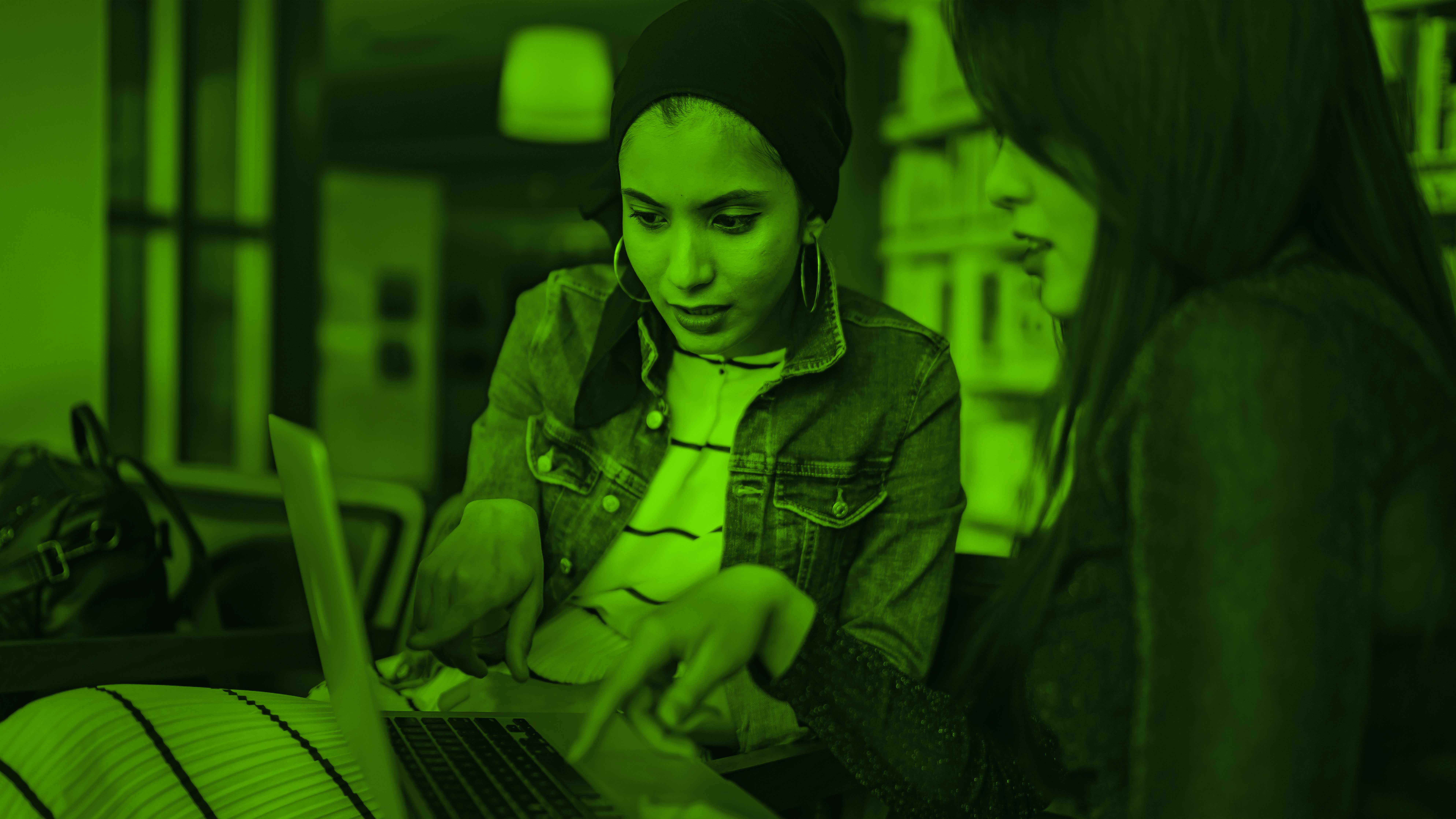 Two women working on a computer