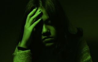 Woman with her head in her hands
