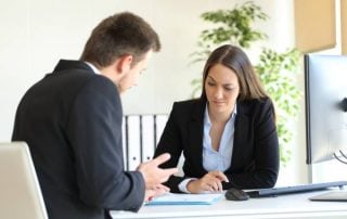 A male and female colleague engage in a conversation