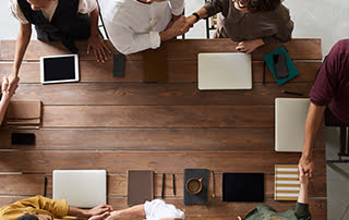 Office aerial shot of group shaking hands