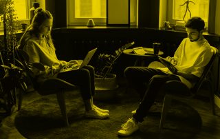 Woman and man sat in home chairs working