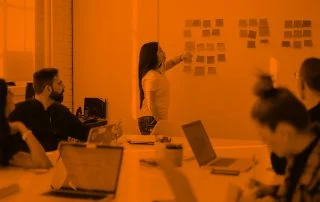 Boardroom meeting with woman leading the presentation