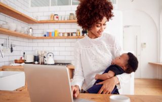 Woman in kitchen holding baby