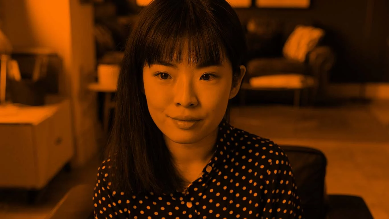 Close up of woman sat down looking to the left