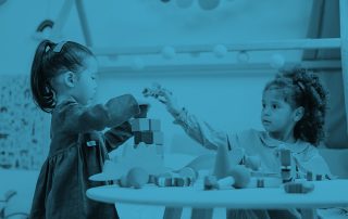 Two children playing at table