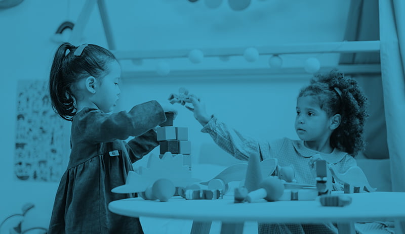 Two children playing at table