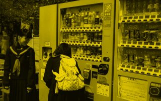Two school girls looking at vending machine