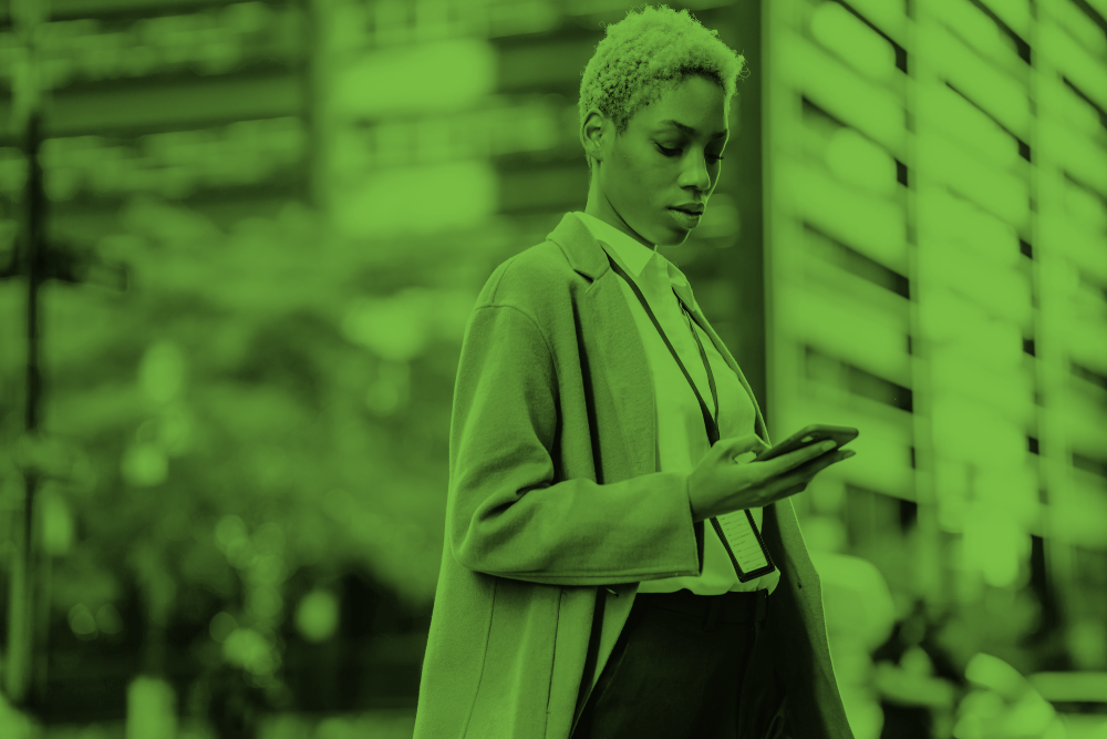 Woman in business wear looking down at her phone