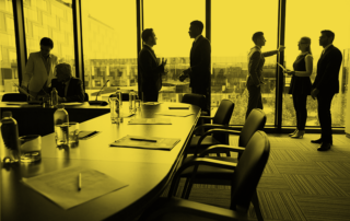 Silhouettes of several delegates standing in conference hall and discussing working points and reports