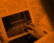 A woman rates a service out of five stars on an iPad.