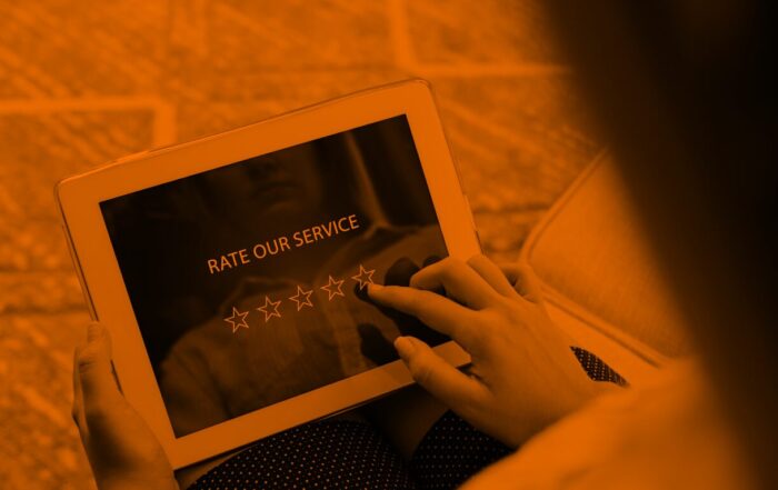 A woman rates a service out of five stars on an iPad.