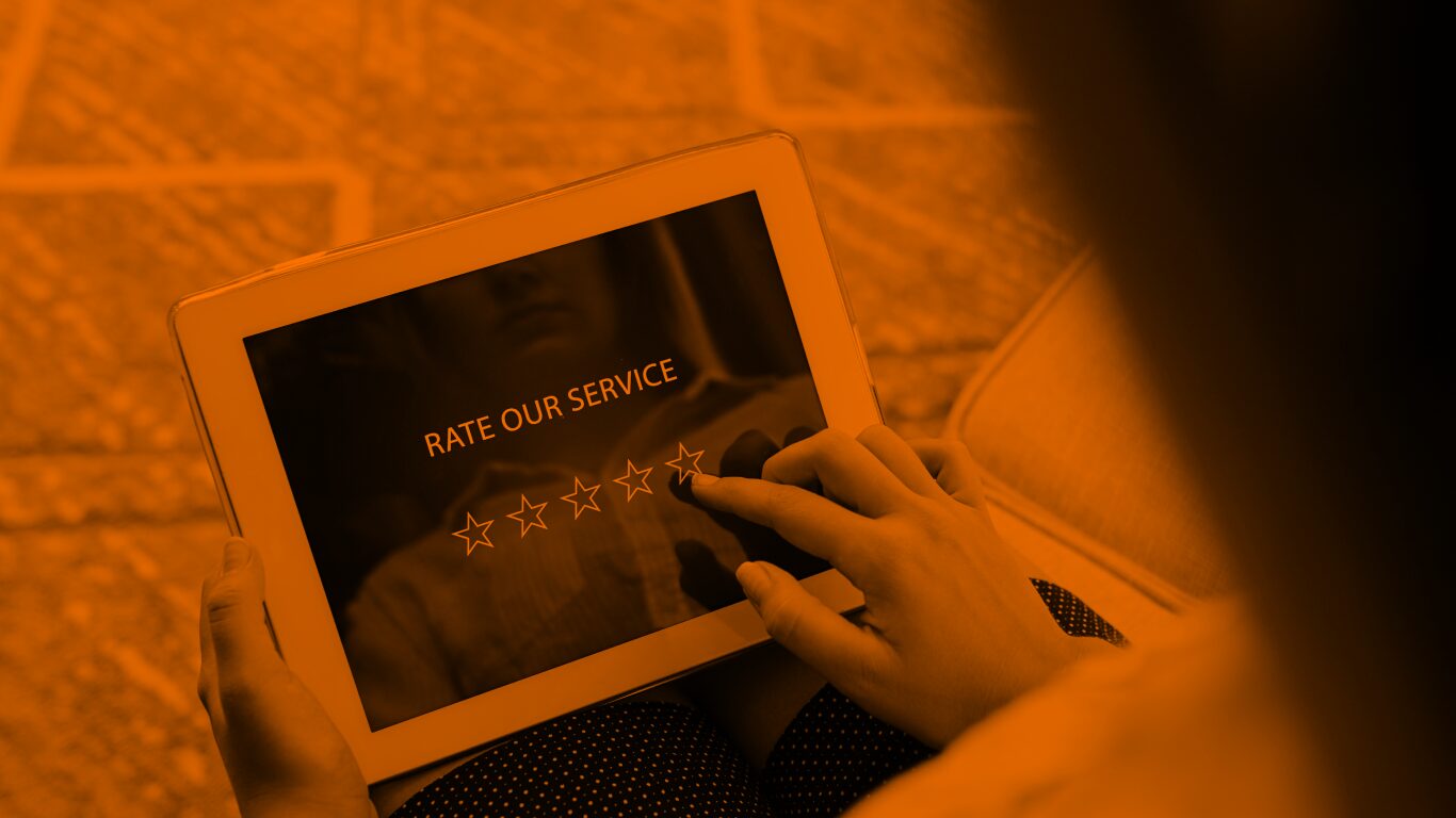 A woman rates a service out of five stars on an iPad.